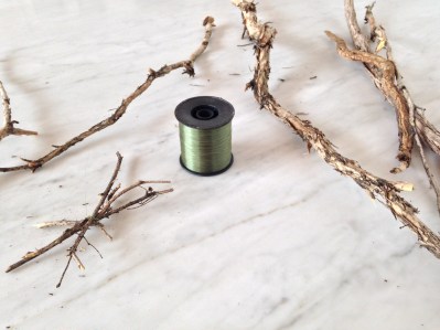 Nylon thread and twigs Luke and I scavenged off the road near our house. This is all you need to start.  You can see here my little twiggy star to place on the top of our tree. 